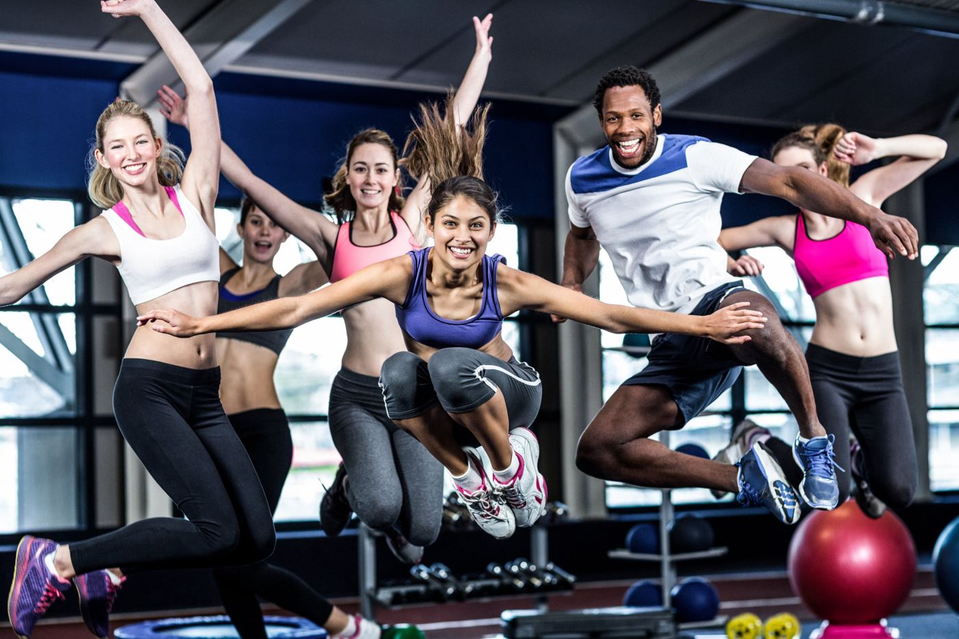 A group of people jumping for joy during a fitness class